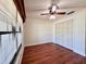An empty bedroom with a large closet, wood-look floors, a window, and a ceiling fan at 1742 Willa Cir, Winter Park, FL 32792