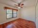 An empty bedroom with wood-look floors, a window, and a ceiling fan at 1742 Willa Cir, Winter Park, FL 32792