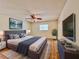 Well-lit staged bedroom with a large bed, wood-look floors, a window, and a ceiling fan at 1742 Willa Cir, Winter Park, FL 32792