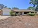 Charming single-story home with a brick and stucco facade and a well-manicured front yard at 1742 Willa Cir, Winter Park, FL 32792