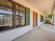 Inviting front porch with a decorative wood front door and large windows at 1742 Willa Cir, Winter Park, FL 32792