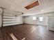 Spacious garage with vinyl flooring, an automatic garage door, and a utility sink with washer and dryer hookups at 1742 Willa Cir, Winter Park, FL 32792