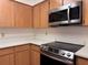 Close-up of a Kitchen featuring wood cabinets, white countertops, and stainless steel appliances at 1742 Willa Cir, Winter Park, FL 32792