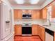 Kitchen featuring wood cabinets, white countertops, and stainless steel appliances at 1742 Willa Cir, Winter Park, FL 32792