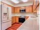 Kitchen featuring wood cabinets, white countertops, and stainless steel appliances at 1742 Willa Cir, Winter Park, FL 32792