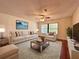 Bright living room with neutral decor, wood floors, ceiling fan and lots of natural light at 1742 Willa Cir, Winter Park, FL 32792