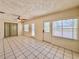 Bright living room featuring neutral paint, tile flooring, and natural light from sliding glass doors and windows at 1742 Willa Cir, Winter Park, FL 32792