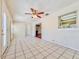Bright living room featuring neutral paint, tile flooring, and an open doorway to other rooms at 1742 Willa Cir, Winter Park, FL 32792