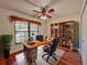 Inviting home office features a ceiling fan, built-in shelving, natural light, and wood flooring at 1742 Willa Cir, Winter Park, FL 32792