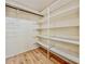 Empty walk-in closet with built-in shelves and wood-look floors at 1742 Willa Cir, Winter Park, FL 32792