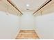 Empty walk-in closet with two clothing bars and wood-look floors at 1742 Willa Cir, Winter Park, FL 32792