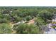 Aerial view showing a townhouse complex surrounded by lush greenery and mature trees at 1748 Foxhall Cir # 1748, Kissimmee, FL 34741