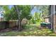 Large backyard with mature trees, a wooden deck, and a fenced perimeter provides a private outdoor living space at 1748 Foxhall Cir # 1748, Kissimmee, FL 34741