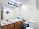 Bathroom featuring a single sink vanity and toilet at 1748 Foxhall Cir # 1748, Kissimmee, FL 34741