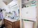 Bathroom with a vanity sink, toilet with overhead shelving and updated fixtures creates a functional space at 1748 Foxhall Cir # 1748, Kissimmee, FL 34741