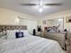 Comfortable bedroom featuring neutral tones, a plush bed with decorative pillows, and a dresser with a large mirror at 1748 Foxhall Cir # 1748, Kissimmee, FL 34741