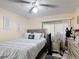 Bedroom with neutral tones, a comfortable bed with decorative pillows, and natural light, creating a cozy retreat at 1748 Foxhall Cir # 1748, Kissimmee, FL 34741