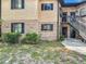 Multi-story townhouse with brick and wood siding plus black trim and staircase leading to the upper levels at 1748 Foxhall Cir # 1748, Kissimmee, FL 34741