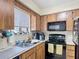 Kitchen sink and countertops with black appliances and wood cabinets at 1748 Foxhall Cir # 1748, Kissimmee, FL 34741