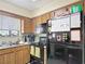 Kitchen with black appliances and wood cabinets at 1748 Foxhall Cir # 1748, Kissimmee, FL 34741