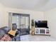 Bright living room featuring tile floors and sliding glass doors to the outside at 1748 Foxhall Cir # 1748, Kissimmee, FL 34741