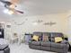 Inviting living room with tile floors, a glass table, and comfy couches at 1748 Foxhall Cir # 1748, Kissimmee, FL 34741