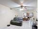 Open-concept room with tile floors seamlessly connects living, dining, and kitchen spaces at 1748 Foxhall Cir # 1748, Kissimmee, FL 34741