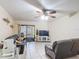 Cozy living room showcasing tile flooring, a ceiling fan, and sliding glass doors at 1748 Foxhall Cir # 1748, Kissimmee, FL 34741