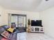 Bright living room featuring tile floors and sliding glass doors to the outside at 1748 Foxhall Cir # 1748, Kissimmee, FL 34741