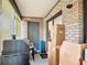 Enclosed patio with a grill and boxes creates an outdoor storage and relaxation space, with access to the backyard at 1748 Foxhall Cir # 1748, Kissimmee, FL 34741