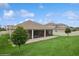 Backyard showing the screened-in porch, a brick patio and a well-maintained grassy area at 1835 Southern Red Oak Ct, Ocoee, FL 34761