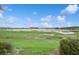 Backyard view featuring a scenic pond and lush greenery at 1835 Southern Red Oak Ct, Ocoee, FL 34761