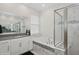 Elegant bathroom with marble tile, soaking tub, and glass-enclosed shower at 1835 Southern Red Oak Ct, Ocoee, FL 34761
