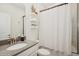 Bright bathroom features a shower and decorative shelving to showcase modern decor at 1835 Southern Red Oak Ct, Ocoee, FL 34761