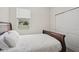Welcoming bedroom with a wood frame bed, and closet with sliding doors at 1835 Southern Red Oak Ct, Ocoee, FL 34761