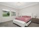 Bright bedroom features plush carpet, modern decor, and a stylish chandelier at 1835 Southern Red Oak Ct, Ocoee, FL 34761