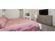Bedroom featuring a plush bed, dresser, TV, and a vanity area with mirror and stool at 1835 Southern Red Oak Ct, Ocoee, FL 34761