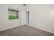 Bright bedroom with plush carpet and view of well-kept landscaping at 1835 Southern Red Oak Ct, Ocoee, FL 34761