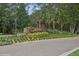 Arden Park's entrance sign surrounded by lush landscaping and mature trees at 1835 Southern Red Oak Ct, Ocoee, FL 34761