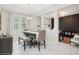 Dining area with a modern table, upholstered chairs, bench seating, white walls, and views into other rooms at 1835 Southern Red Oak Ct, Ocoee, FL 34761