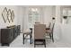 Elegant dining area with a modern table, upholstered chairs, bench seating, and marble floors at 1835 Southern Red Oak Ct, Ocoee, FL 34761