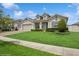 Beautiful one-story home boasts a lush lawn and a three-car garage at 1835 Southern Red Oak Ct, Ocoee, FL 34761