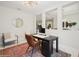 Bright home office with modern desk, stylish chair, rug, and access to other living spaces at 1835 Southern Red Oak Ct, Ocoee, FL 34761