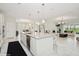 Open layout of kitchen featuring a long island bar, modern white cabinets, and living area at 1835 Southern Red Oak Ct, Ocoee, FL 34761