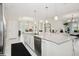 Open kitchen with island bar, stainless steel appliances, and access to living room at 1835 Southern Red Oak Ct, Ocoee, FL 34761