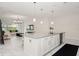Open-concept kitchen with white cabinets, a large island, and stainless steel appliances open to the living room at 1835 Southern Red Oak Ct, Ocoee, FL 34761
