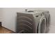 The laundry room features modern GE washer and dryer units for efficient chore management at 1835 Southern Red Oak Ct, Ocoee, FL 34761