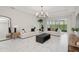 Spacious living room with marble floors, modern furnishings, and sliding glass doors at 1835 Southern Red Oak Ct, Ocoee, FL 34761