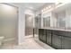 Bathroom features a tiled shower, granite counters, and dark cabinets at 1997 Standing Rock Cir, Oakland, FL 34787