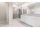 Modern bathroom featuring a double vanity with granite countertops and a glass-enclosed shower at 1997 Standing Rock Cir, Oakland, FL 34787
